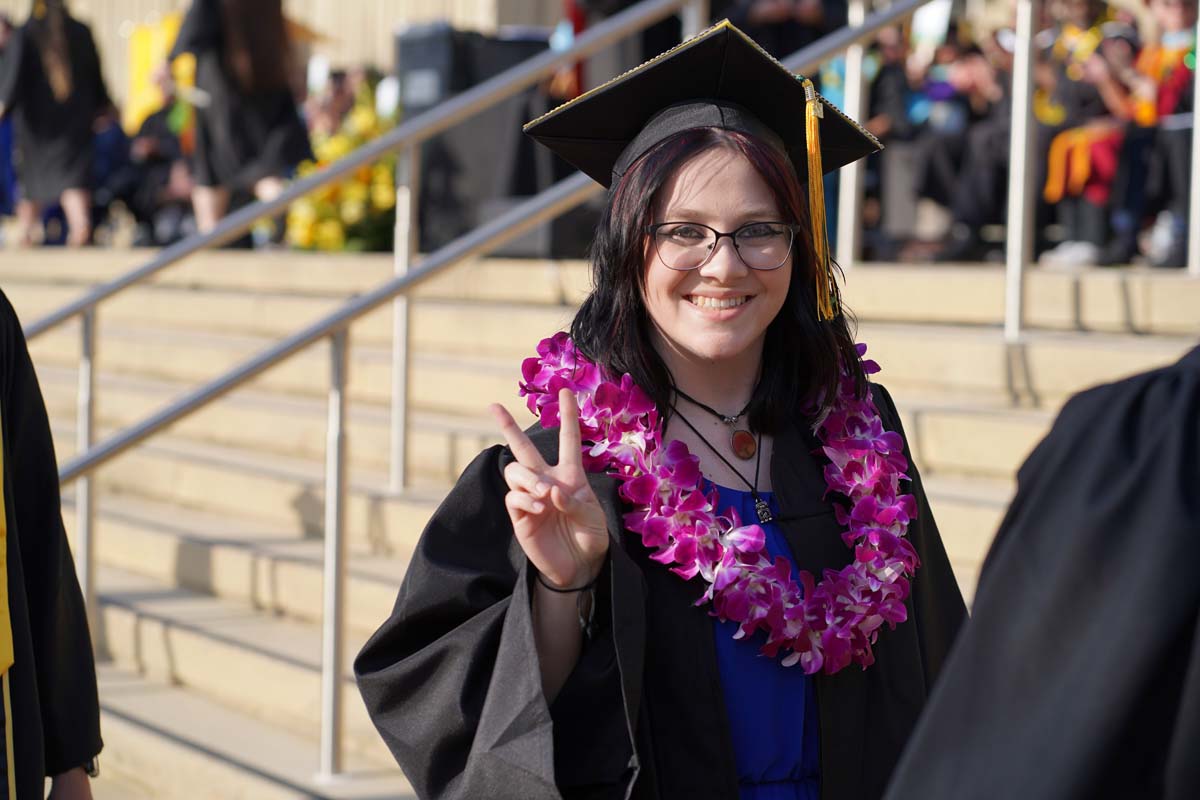 Graduates walk to stage at CHC's Commencement 2024.