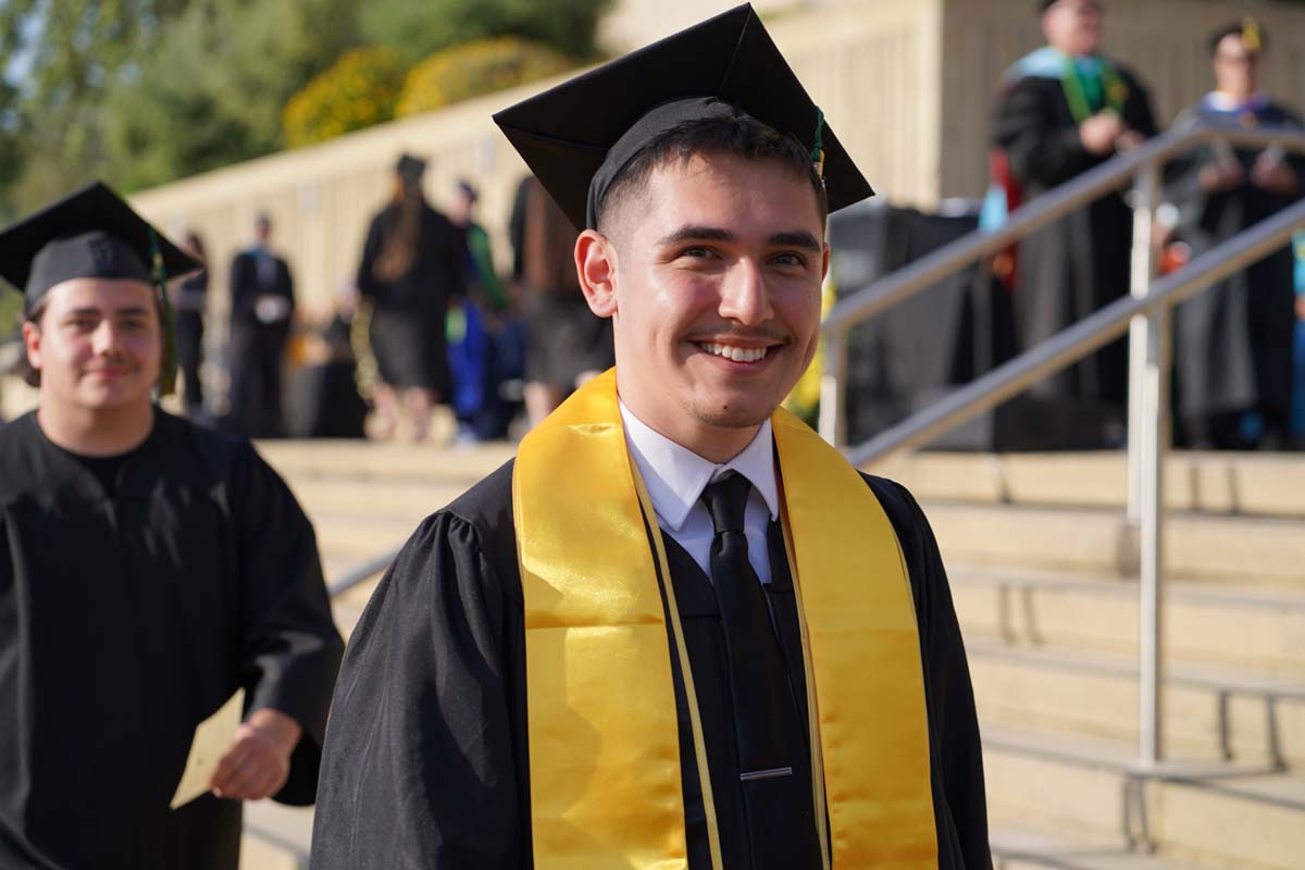 Graduates walk to stage at CHC's Commencement 2024.
