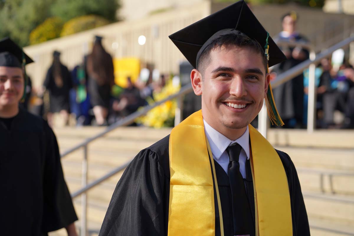 Graduates walk to stage at CHC's Commencement 2024.