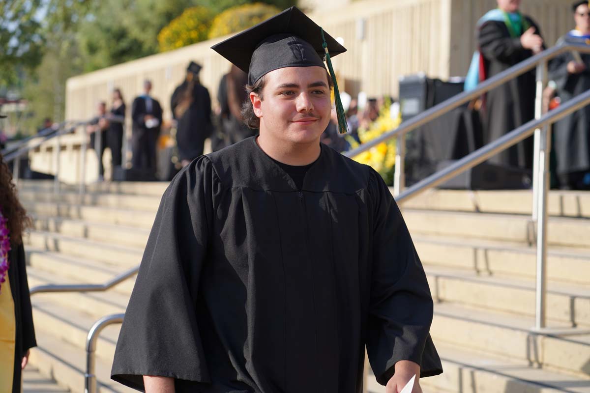 Graduates walk to stage at CHC's Commencement 2024.