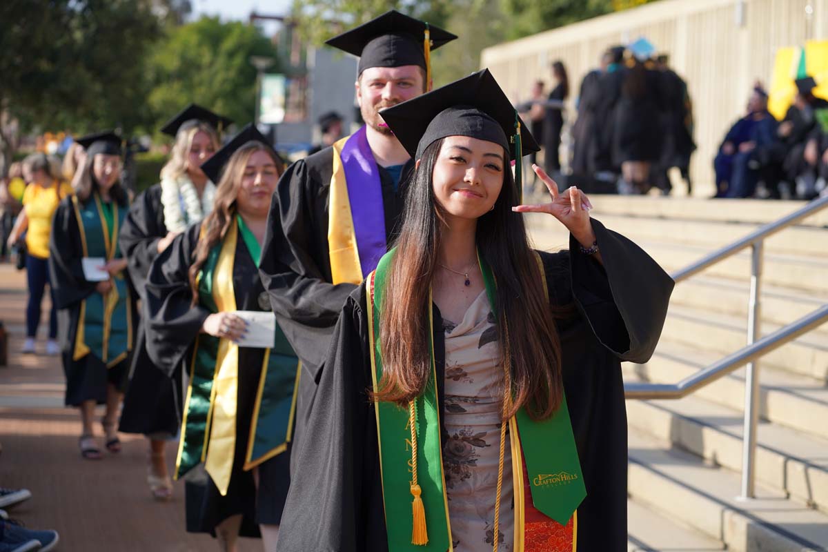Graduates walk to stage at CHC's Commencement 2024.