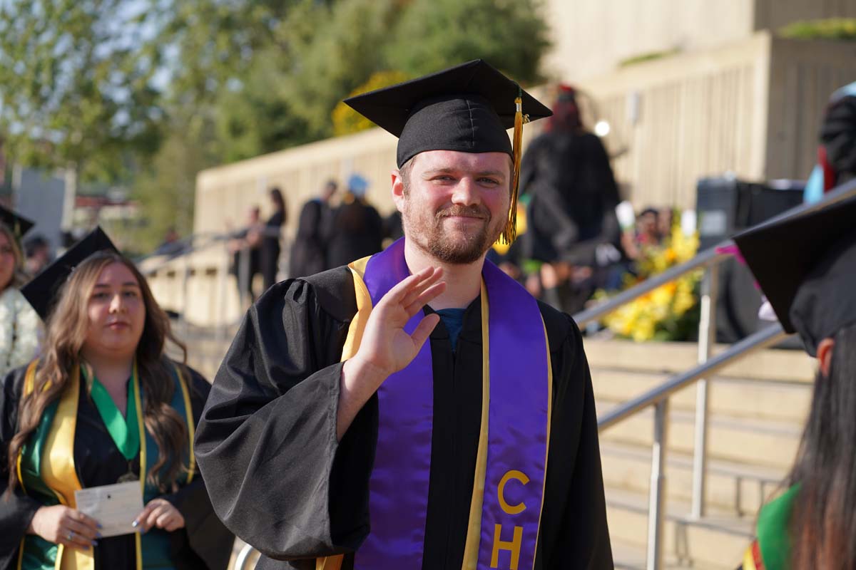 Graduates walk to stage at CHC's Commencement 2024.