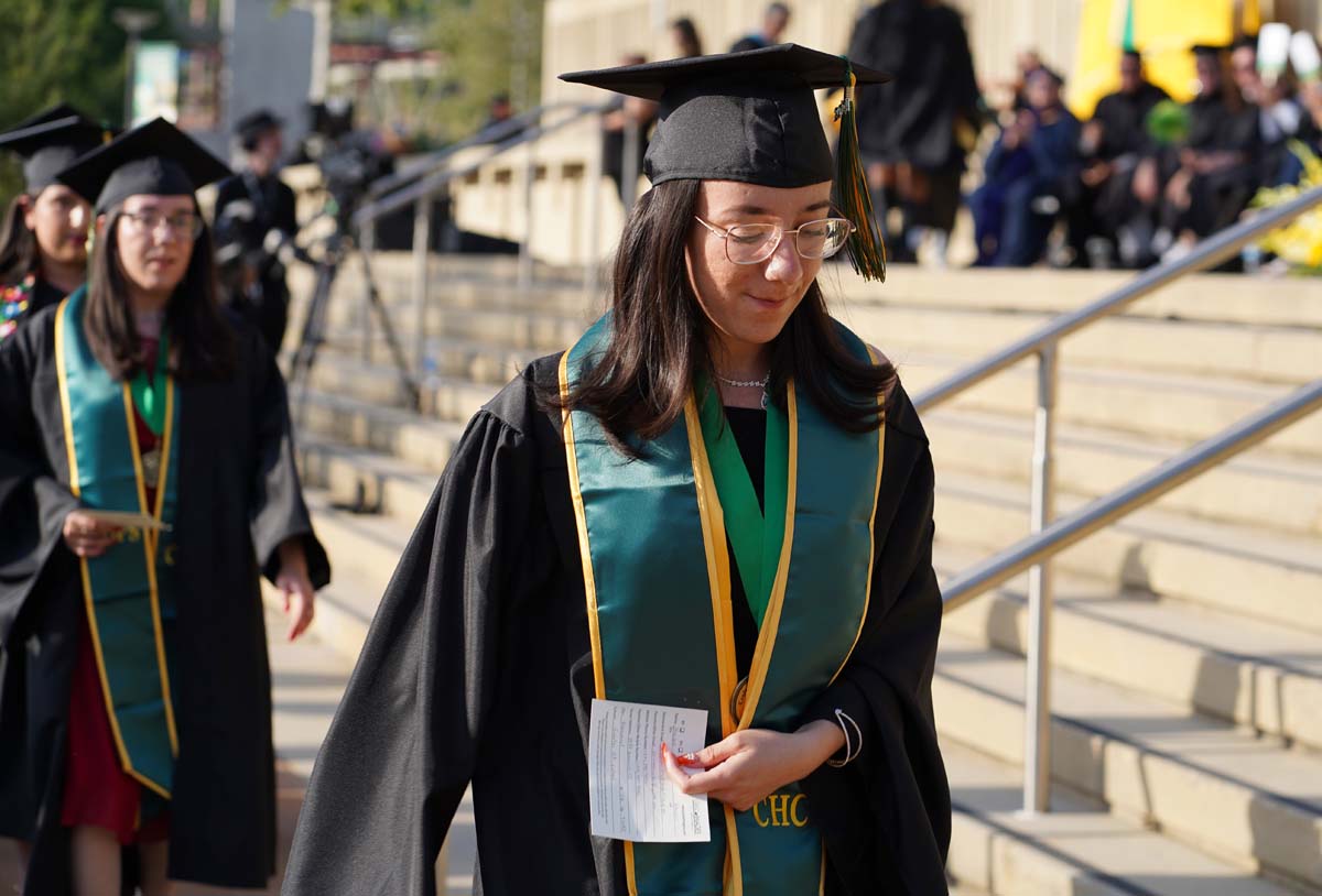 Graduates walk to stage at CHC's Commencement 2024.