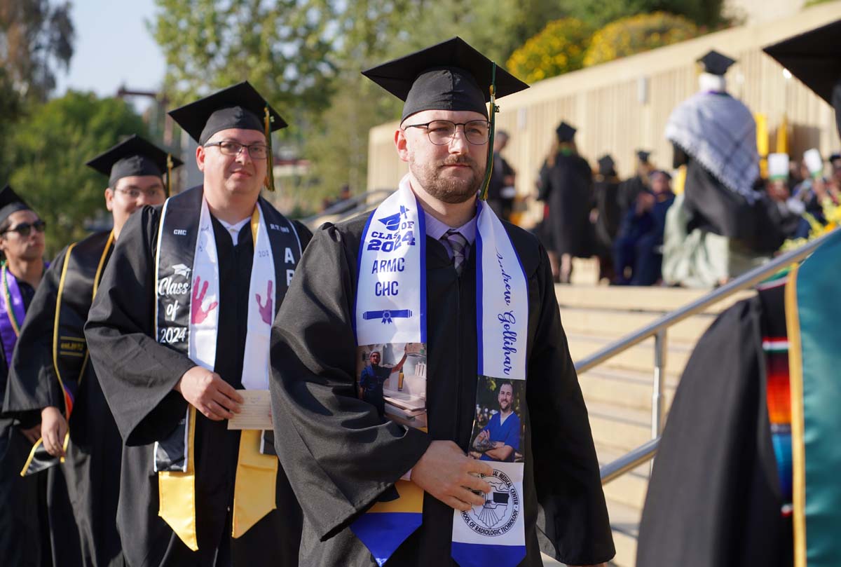 Graduates walk to stage at CHC's Commencement 2024.