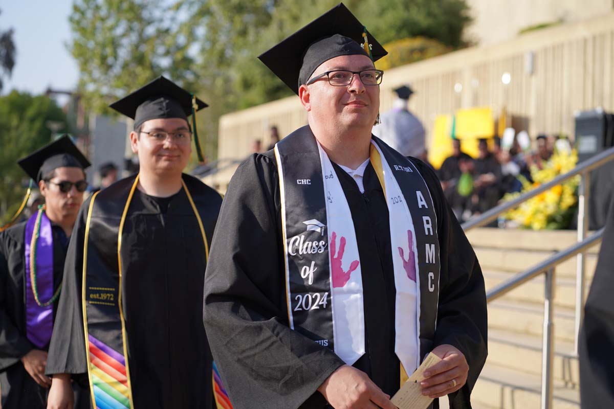 Graduates walk to stage at CHC's Commencement 2024.
