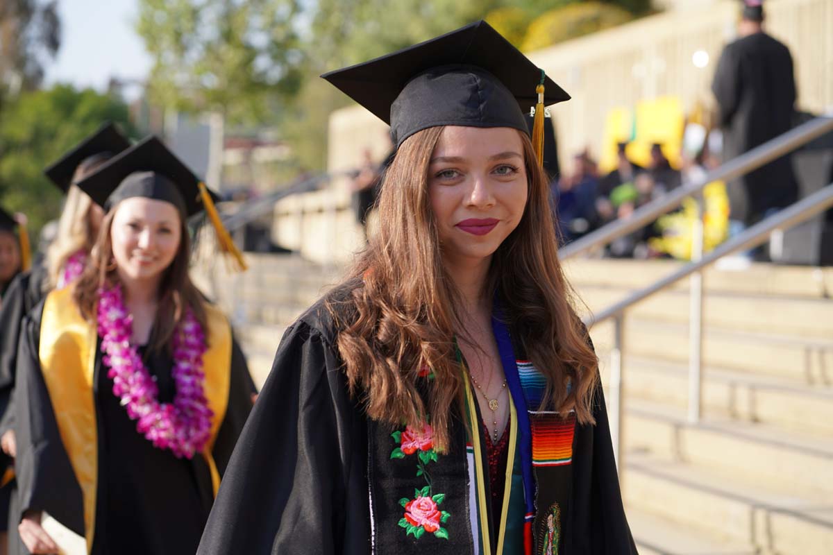 Graduates walk to stage at CHC's Commencement 2024.