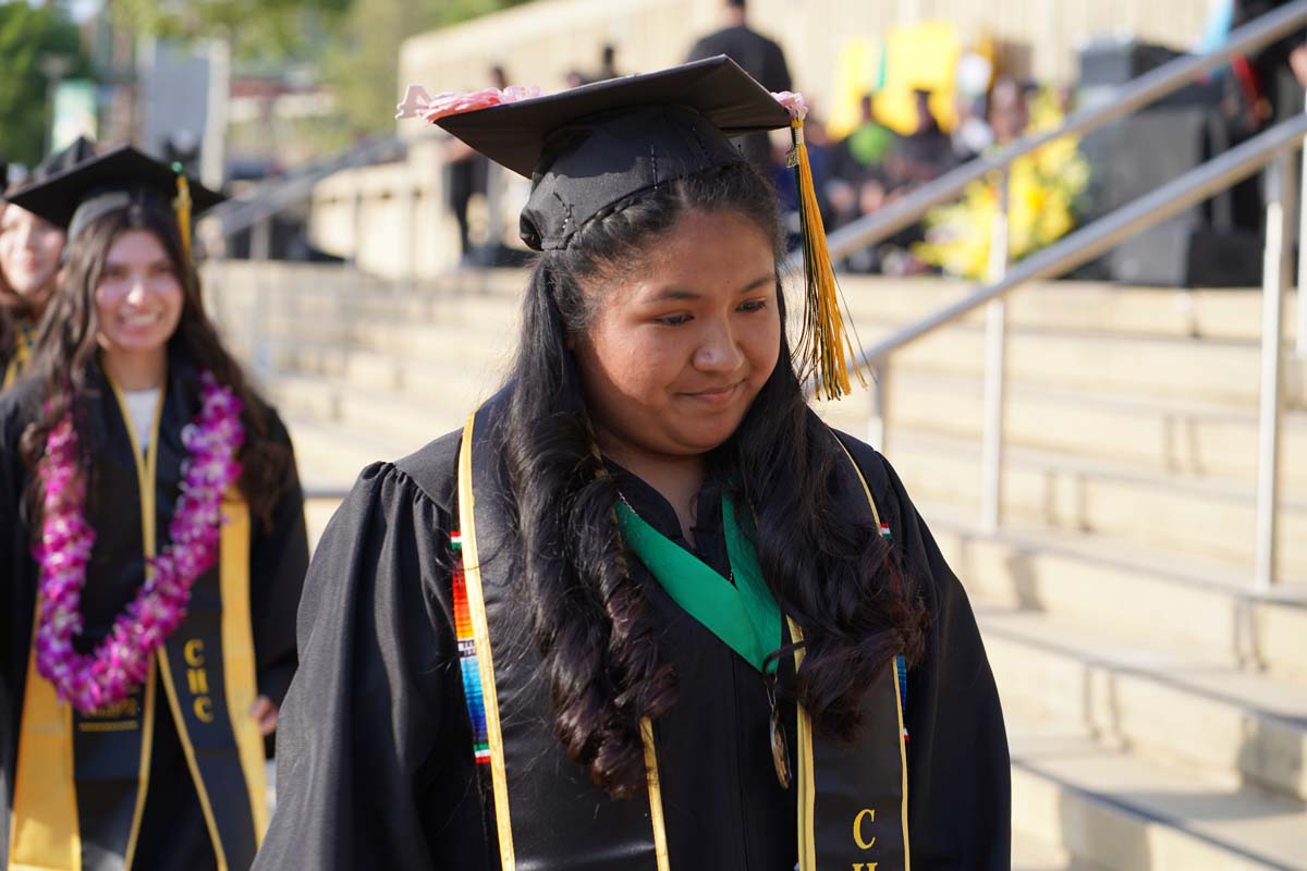 Graduates walk to stage at CHC's Commencement 2024.