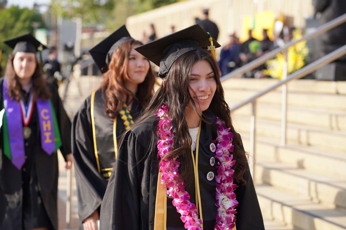 Graduates walk to stage at CHC's Commencement 2024.