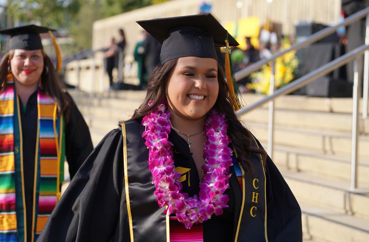 Graduates walk to stage at CHC's Commencement 2024.