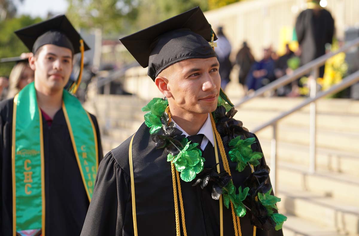 Graduates walk to stage at CHC's Commencement 2024.