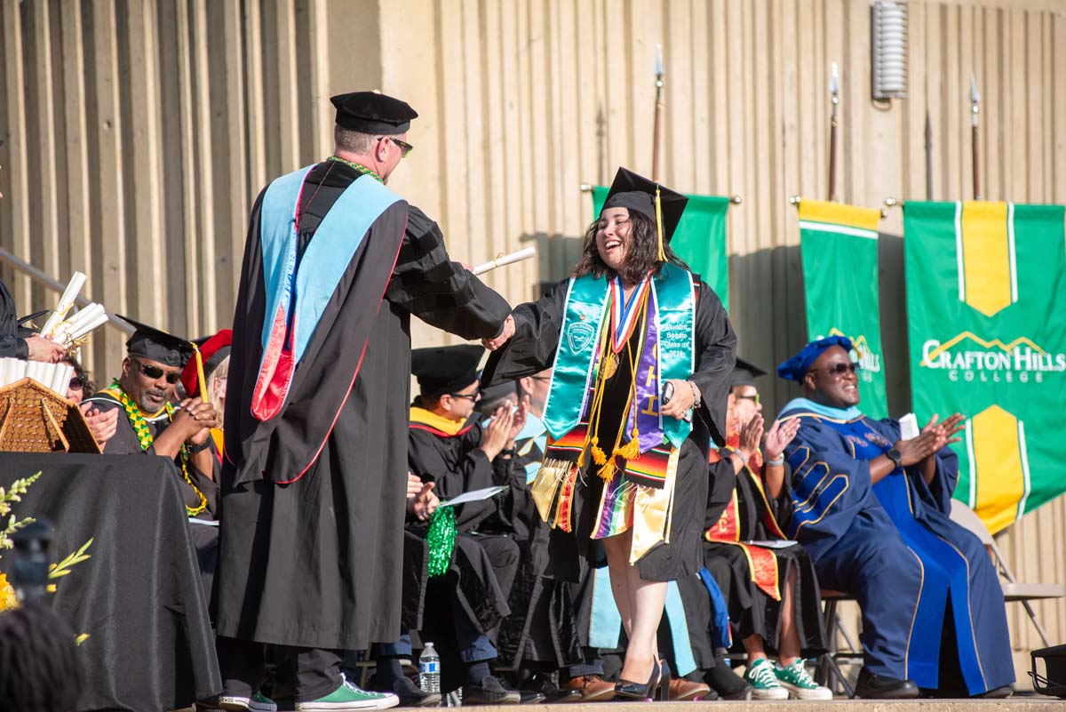 Graduates walk across stage at CHC Commencement 2024.