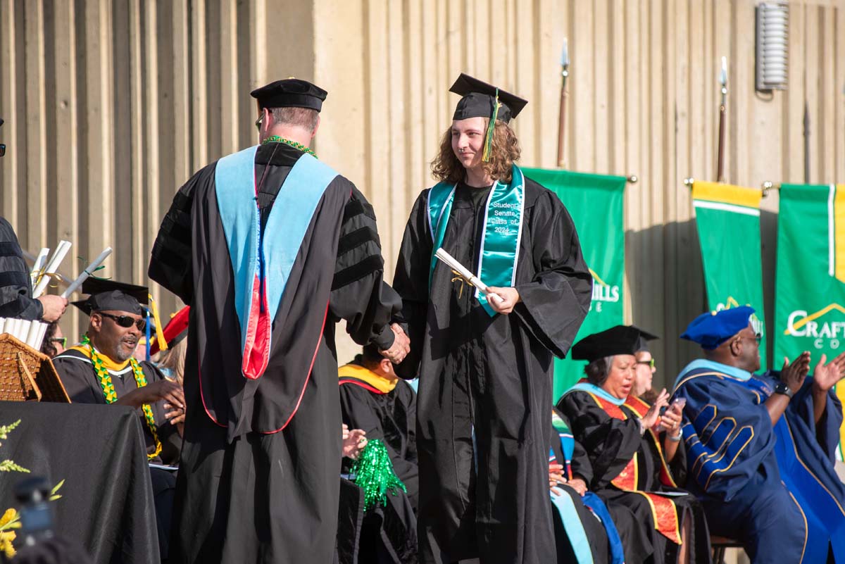 Graduates walk across stage at CHC Commencement 2024.