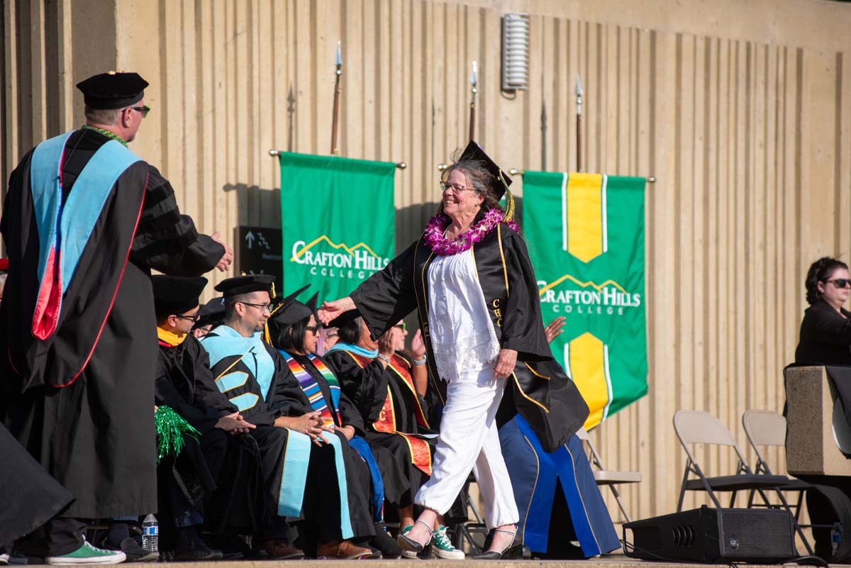 Graduates walk across stage at CHC Commencement 2024.