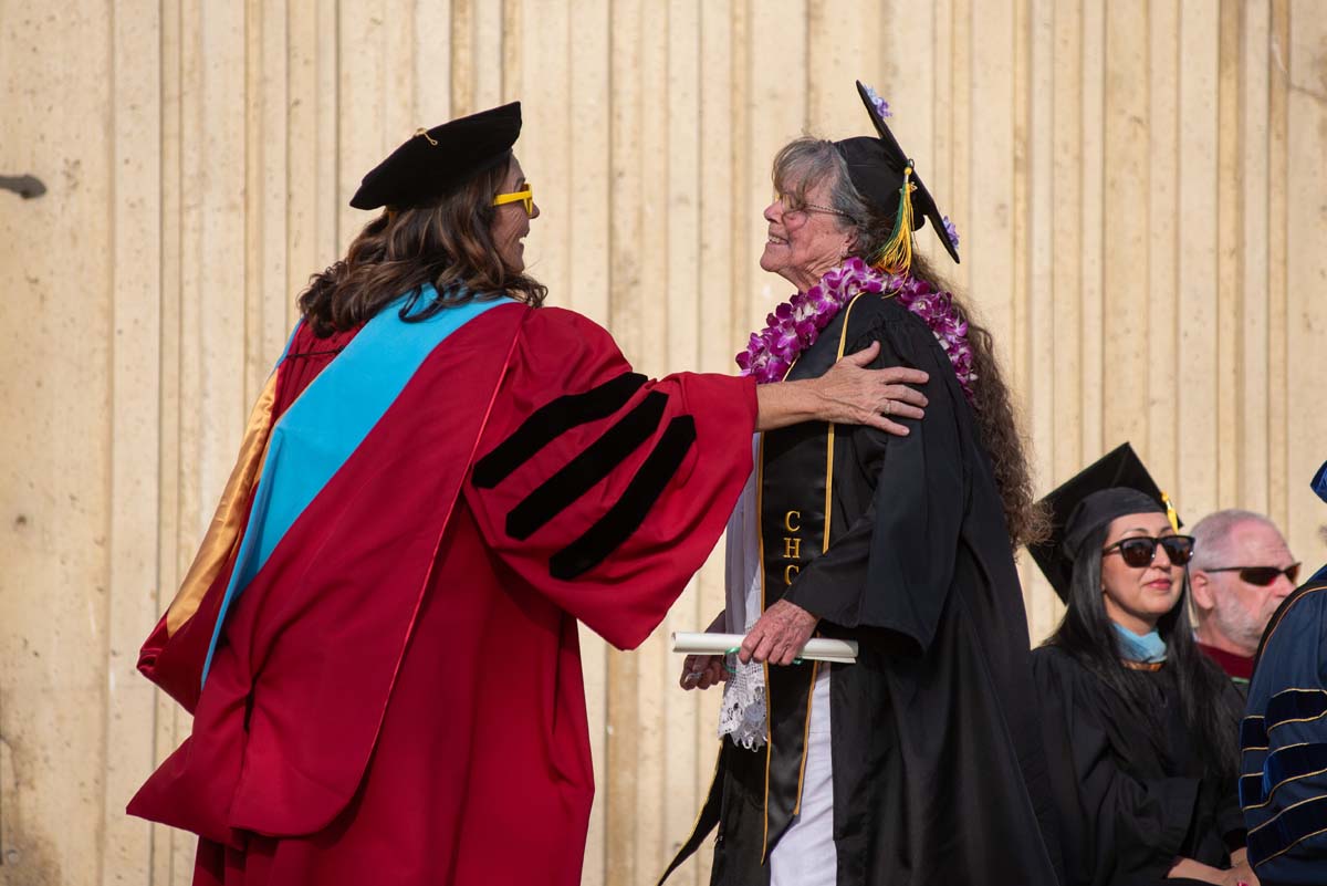 Graduates walk across stage at CHC Commencement 2024.
