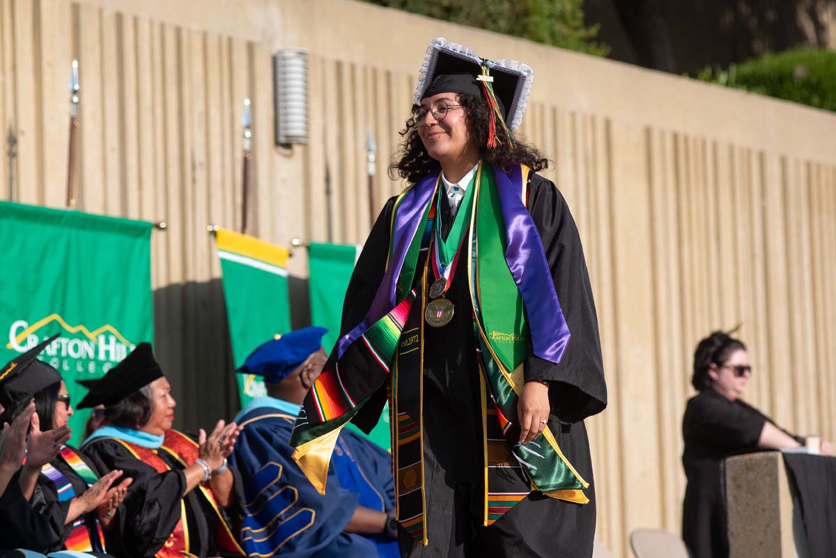 Graduates walk across stage at CHC Commencement 2024.
