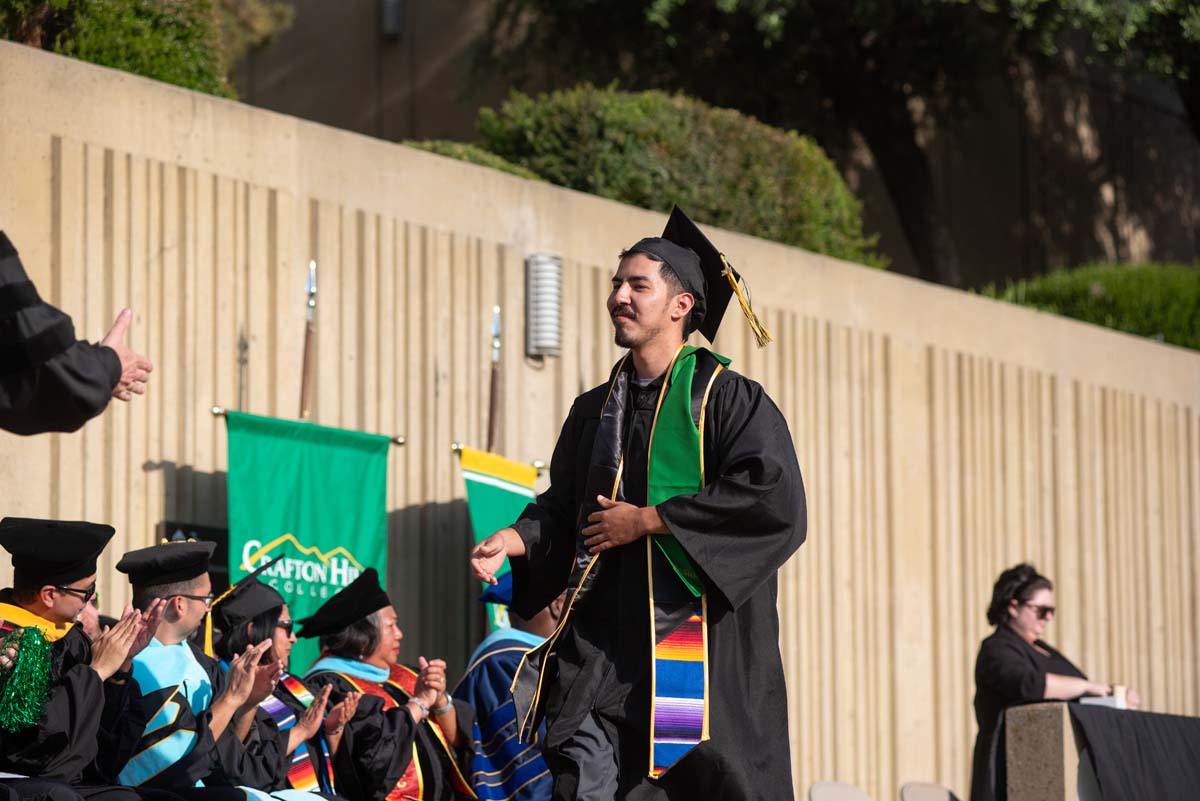 Graduates walk across stage at CHC Commencement 2024.