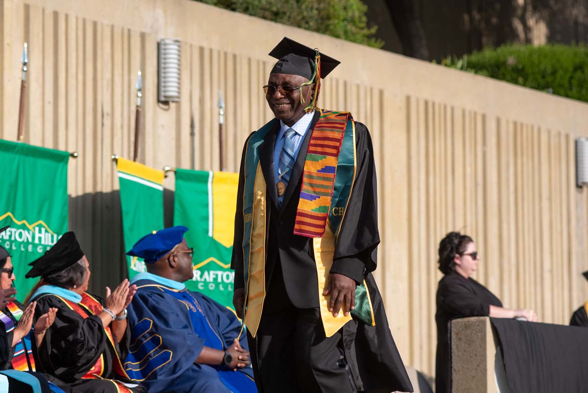 Graduates walk across stage at CHC Commencement 2024.