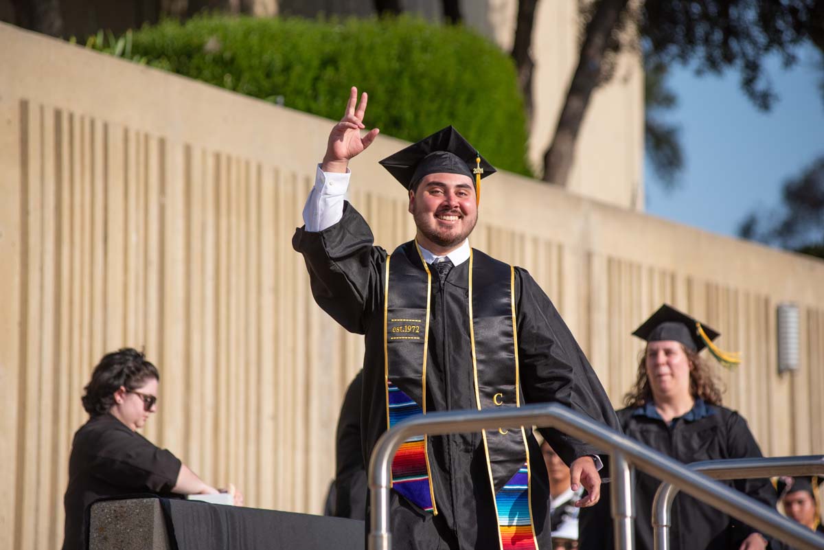 Graduates walk across stage at CHC Commencement 2024.