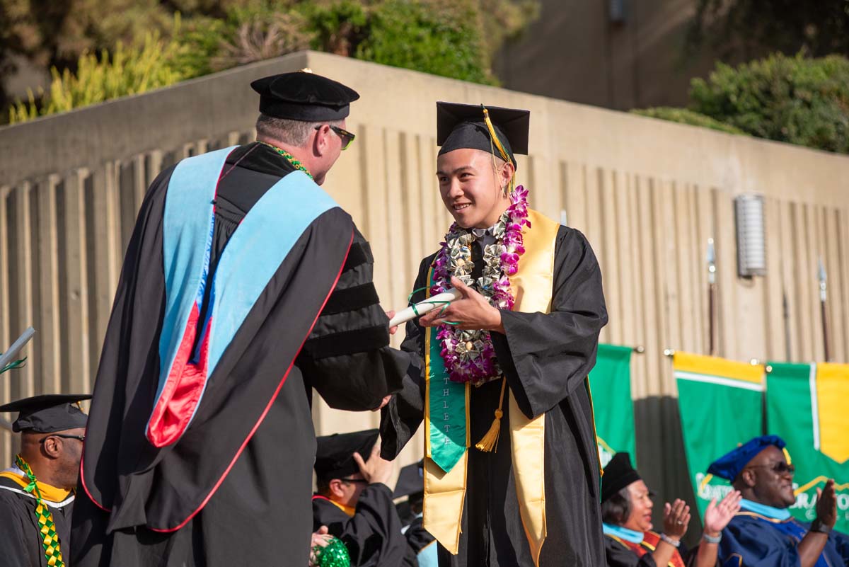 Graduates walk across stage at CHC Commencement 2024.