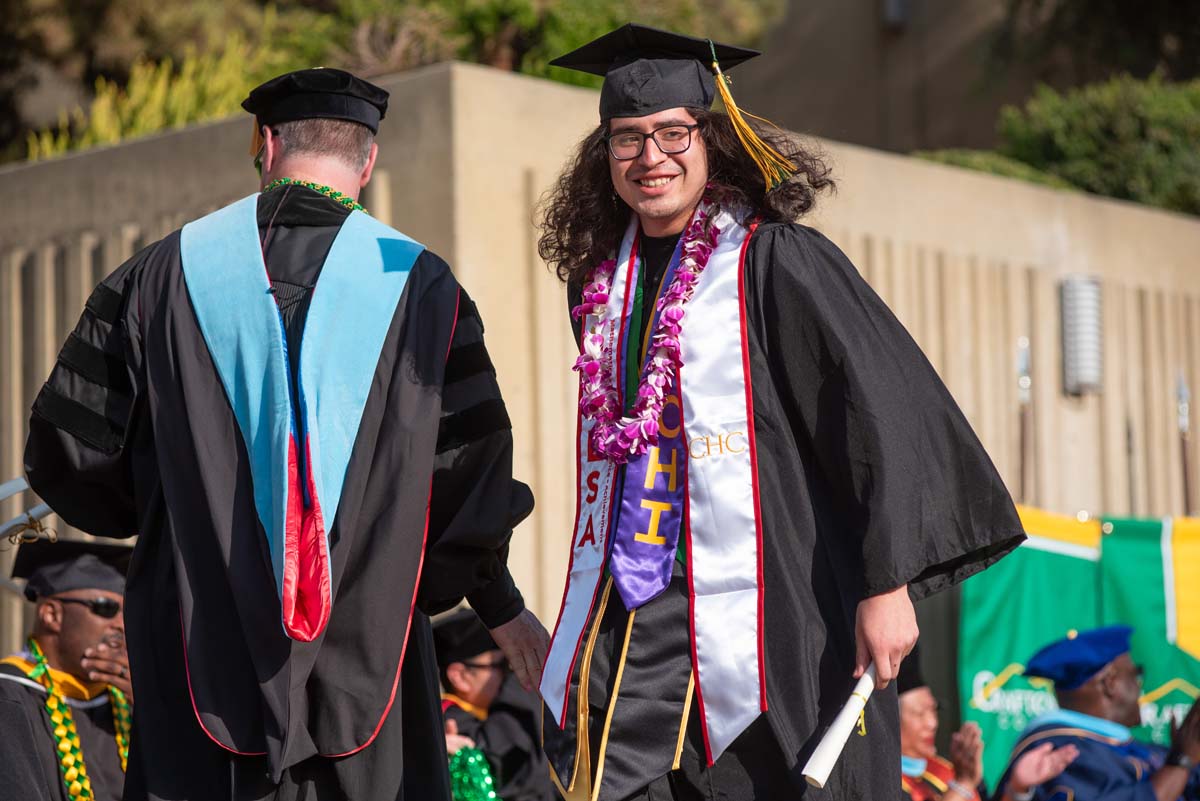 Graduates walk across stage at CHC Commencement 2024.