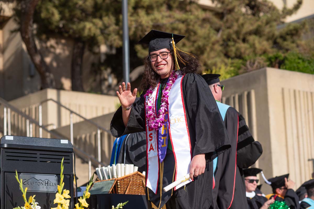 Graduates walk across stage at CHC Commencement 2024.