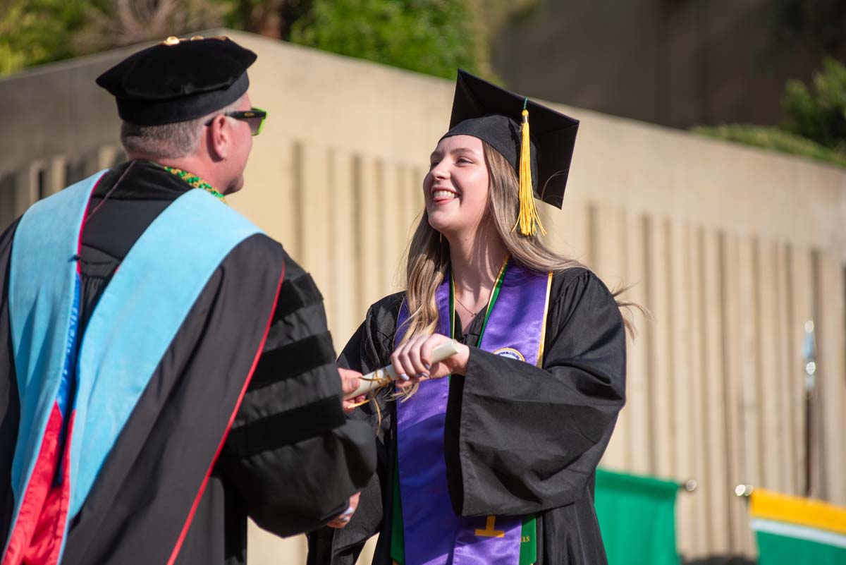 Graduates walk across stage at CHC Commencement 2024.