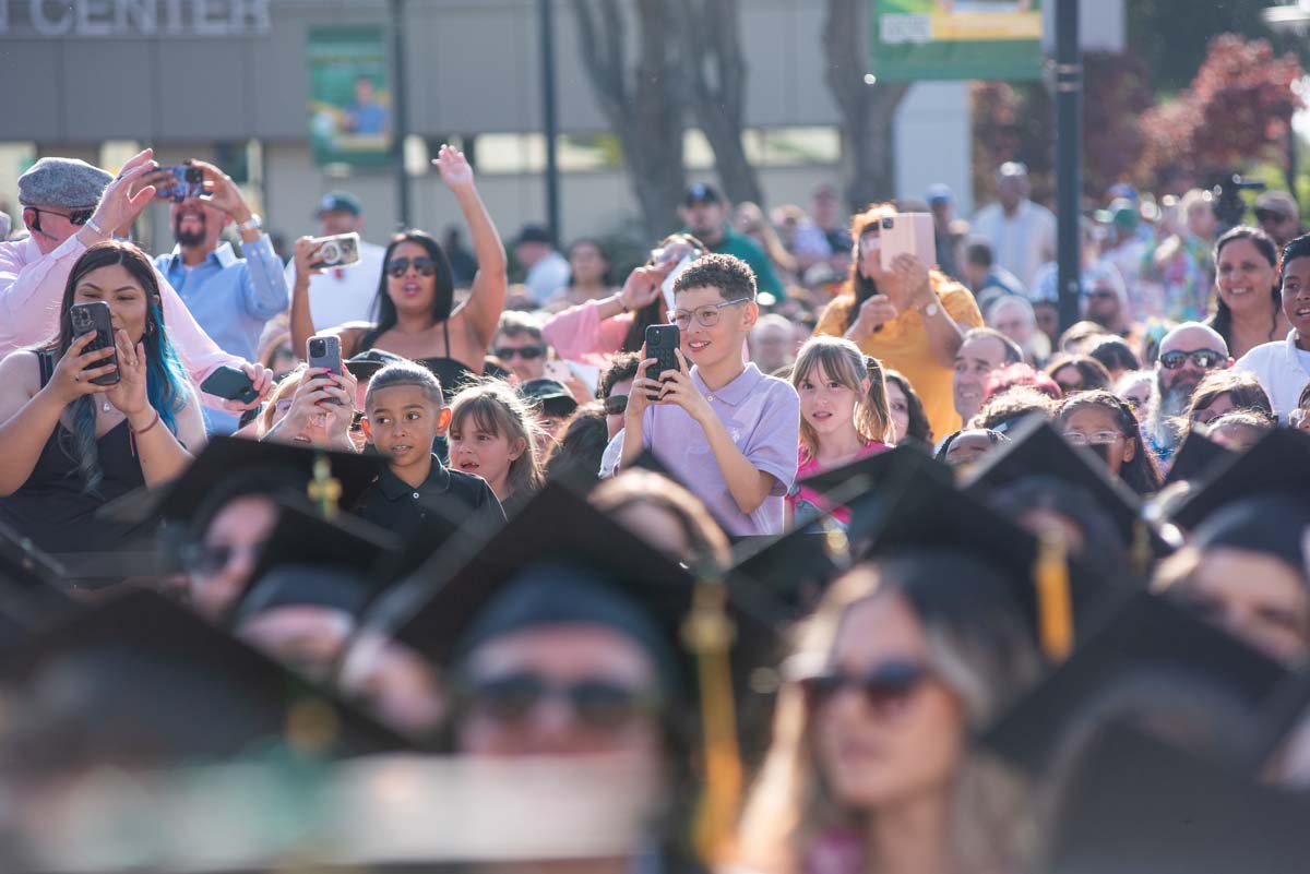 Graduates walk across stage at CHC Commencement 2024.