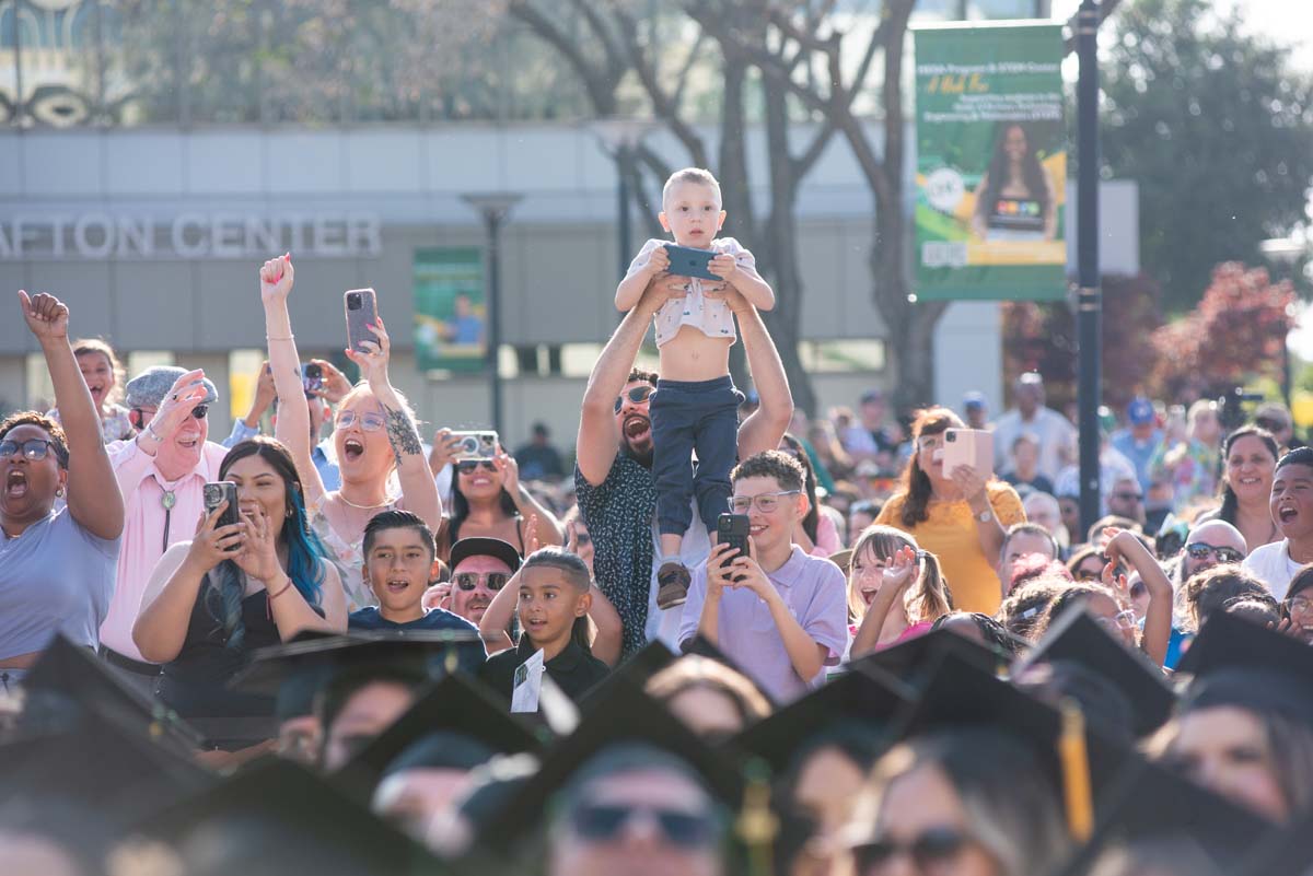 Graduates walk across stage at CHC Commencement 2024.