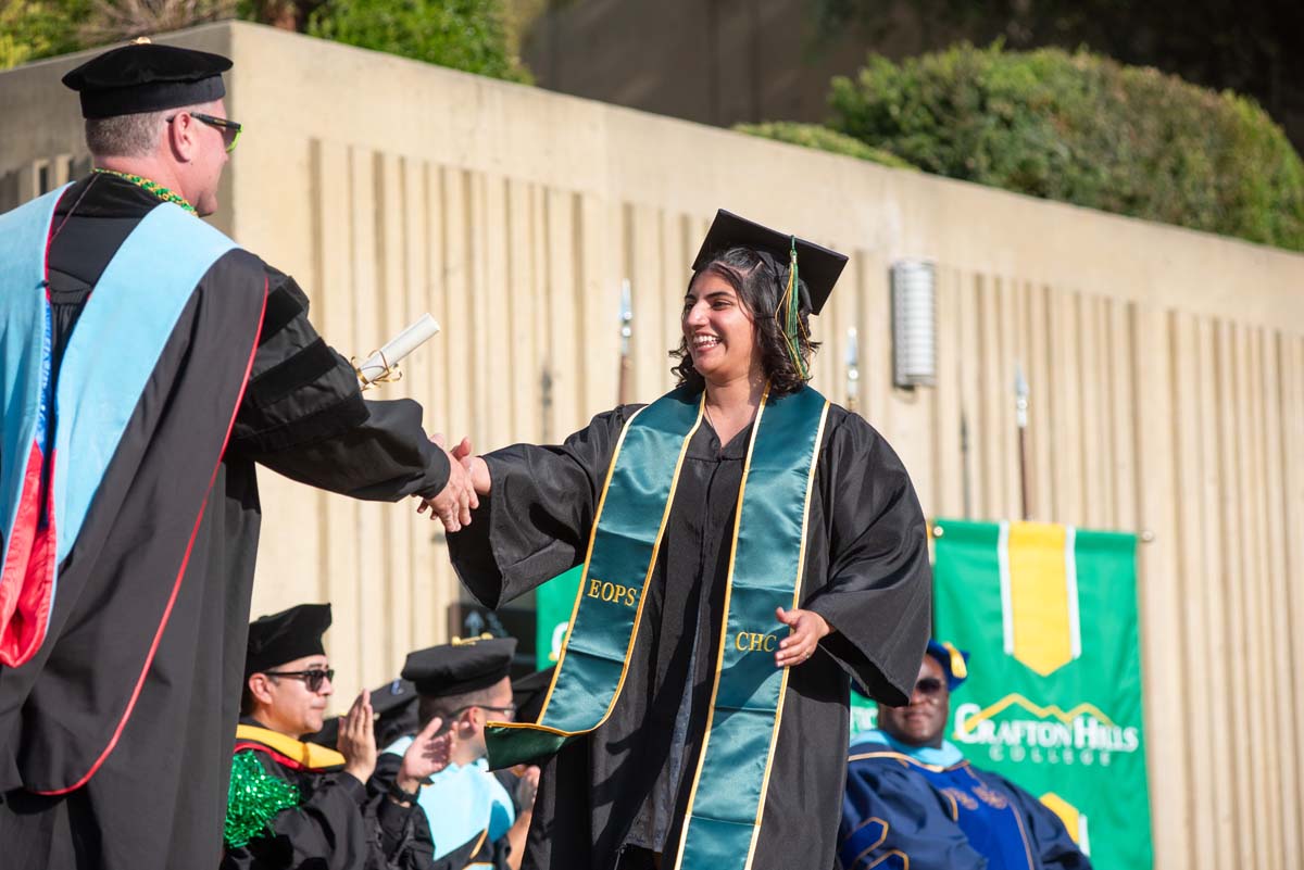 Graduates walk across stage at CHC Commencement 2024.