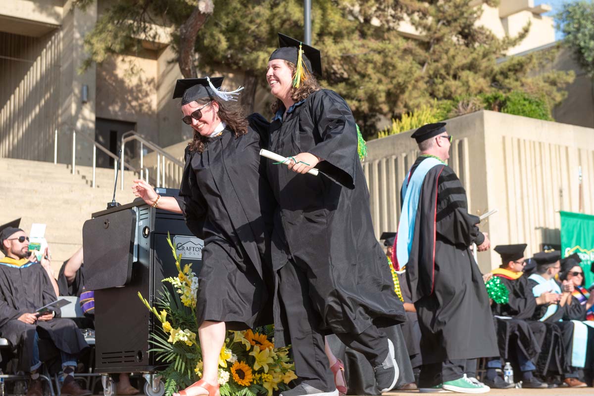 Graduates walk across stage at CHC Commencement 2024.