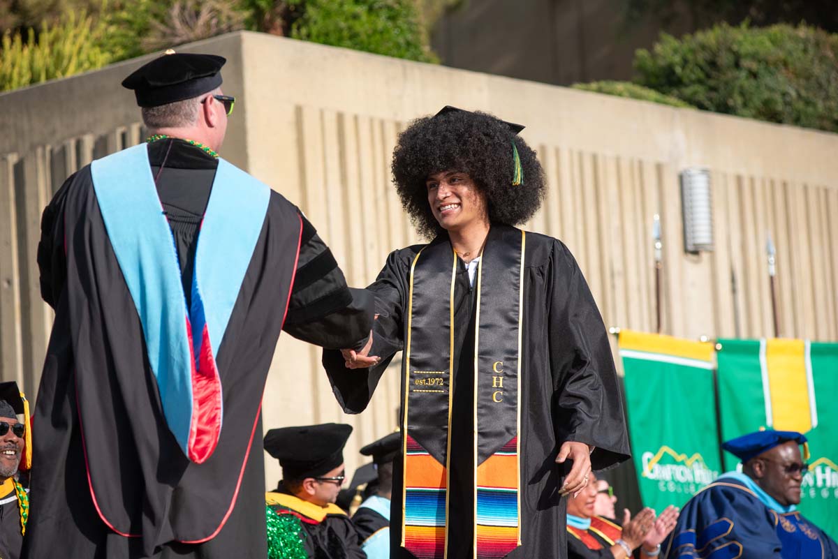 Graduates walk across stage at CHC Commencement 2024.
