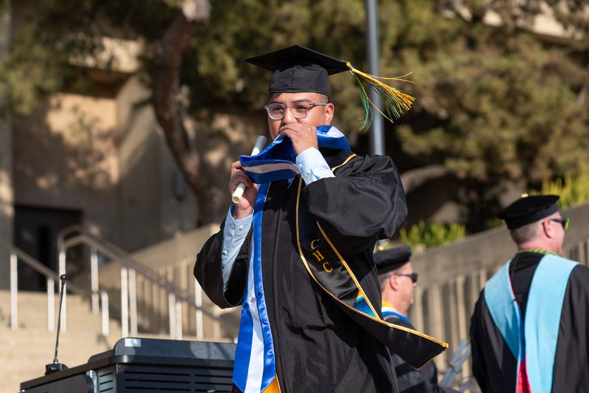 Graduates walk across stage at CHC Commencement 2024.