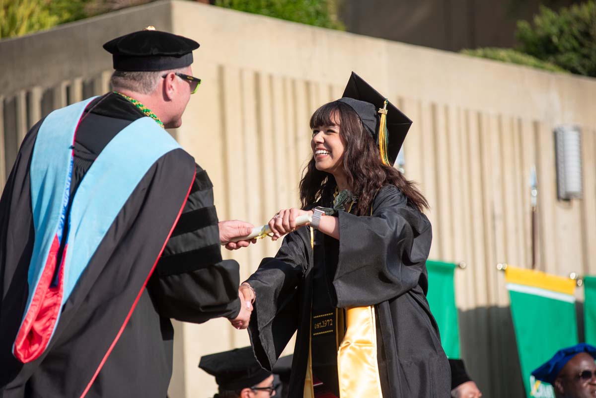 Graduates walk across stage at CHC Commencement 2024.