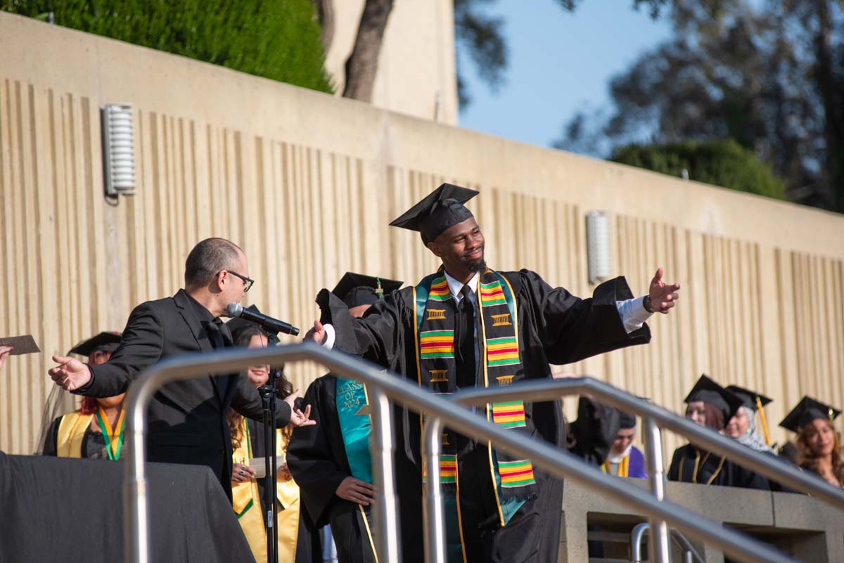 Graduates walk across stage at CHC Commencement 2024.