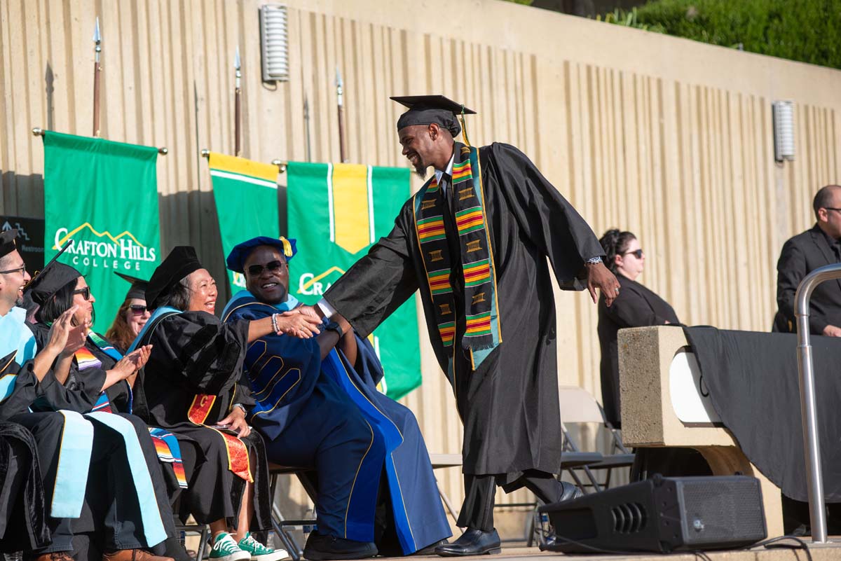 Graduates walk across stage at CHC Commencement 2024.