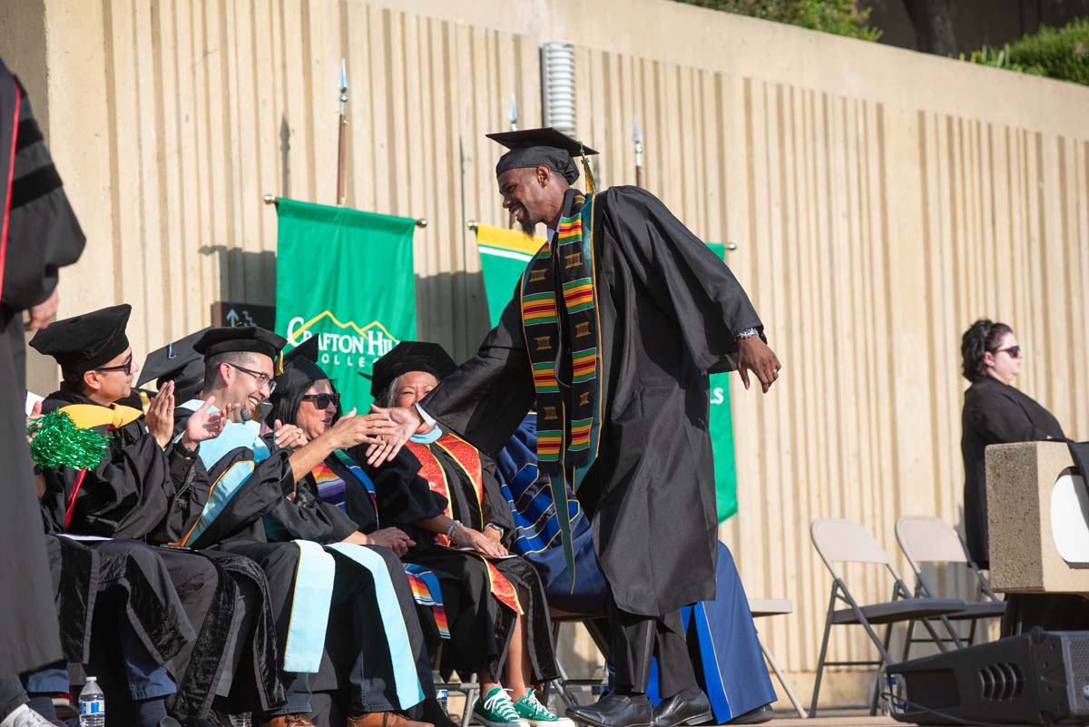 Graduates walk across stage at CHC Commencement 2024.