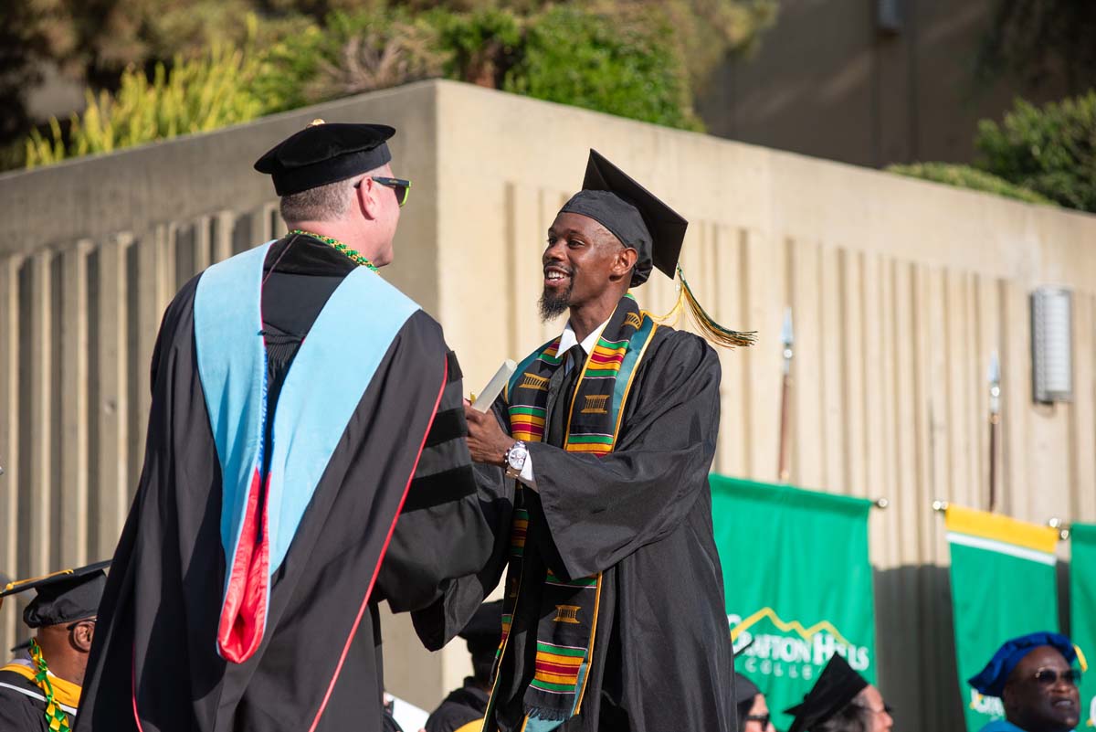 Graduates walk across stage at CHC Commencement 2024.