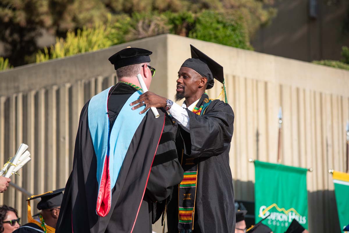 Graduates walk across stage at CHC Commencement 2024.