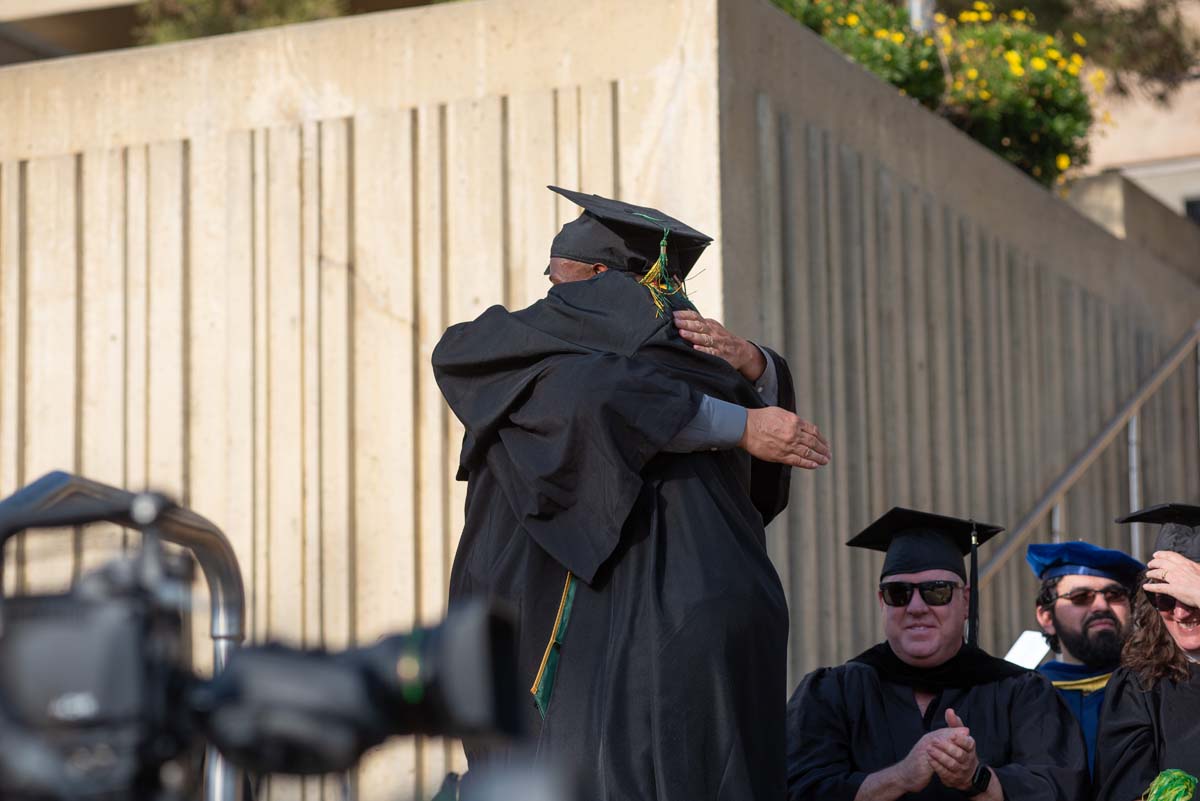 Graduates walk across stage at CHC Commencement 2024.
