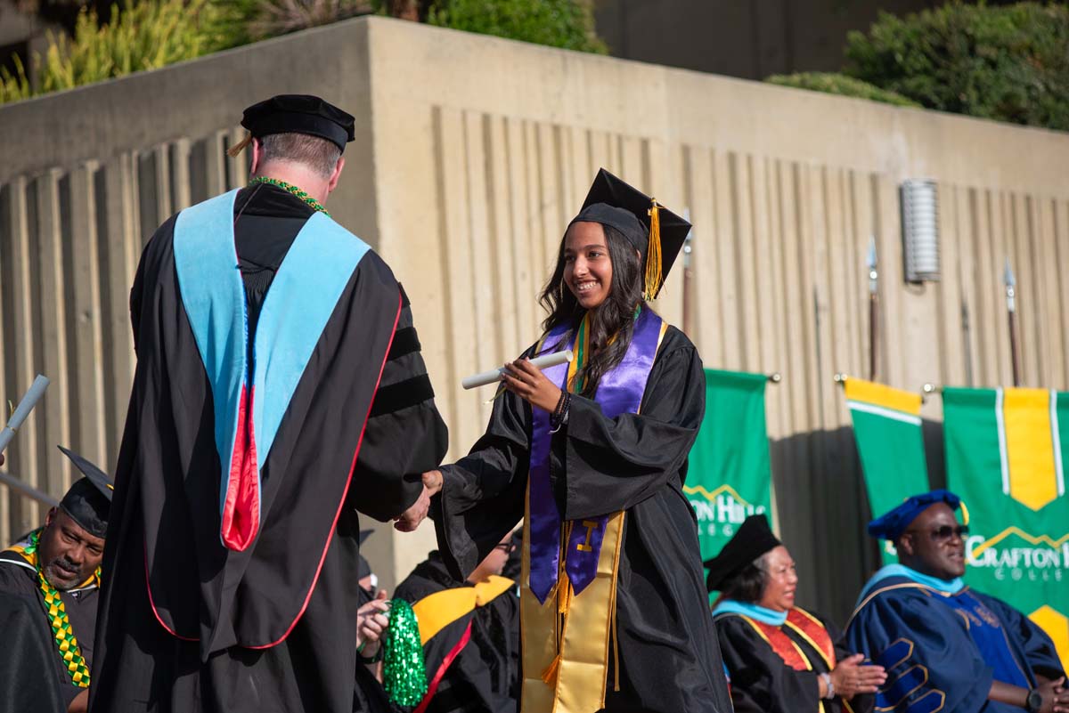 Graduates walk across stage at CHC Commencement 2024.