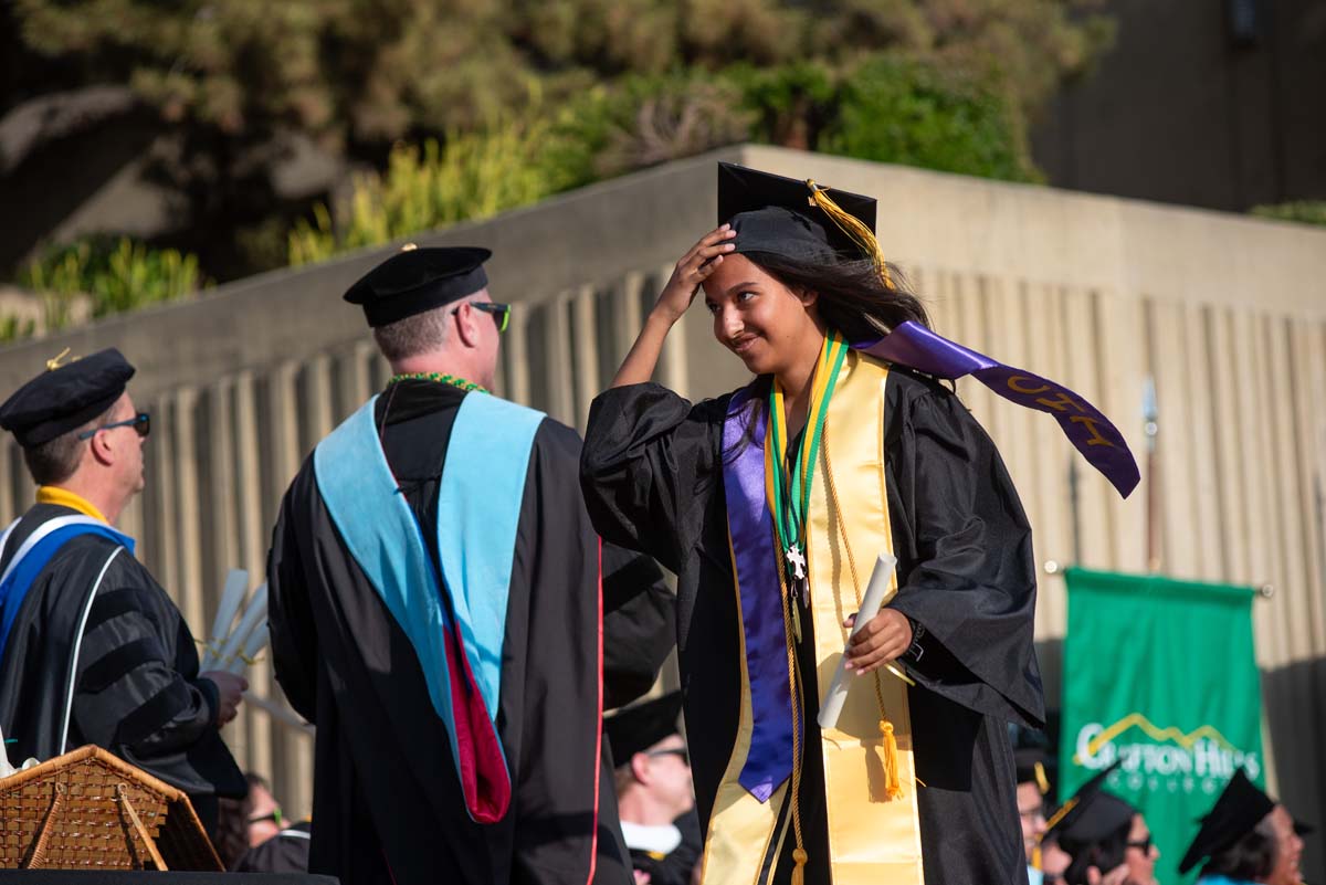 Graduates walk across stage at CHC Commencement 2024.