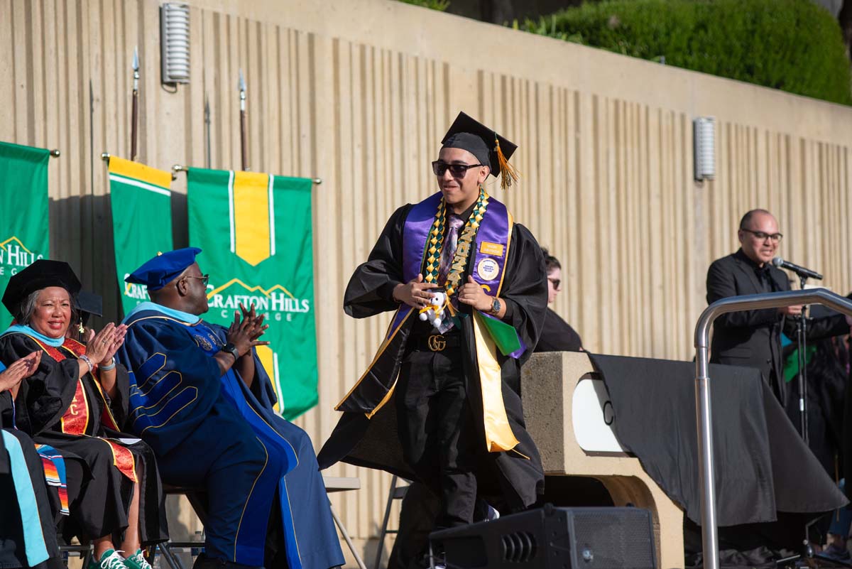 Graduates walk across stage at CHC Commencement 2024.