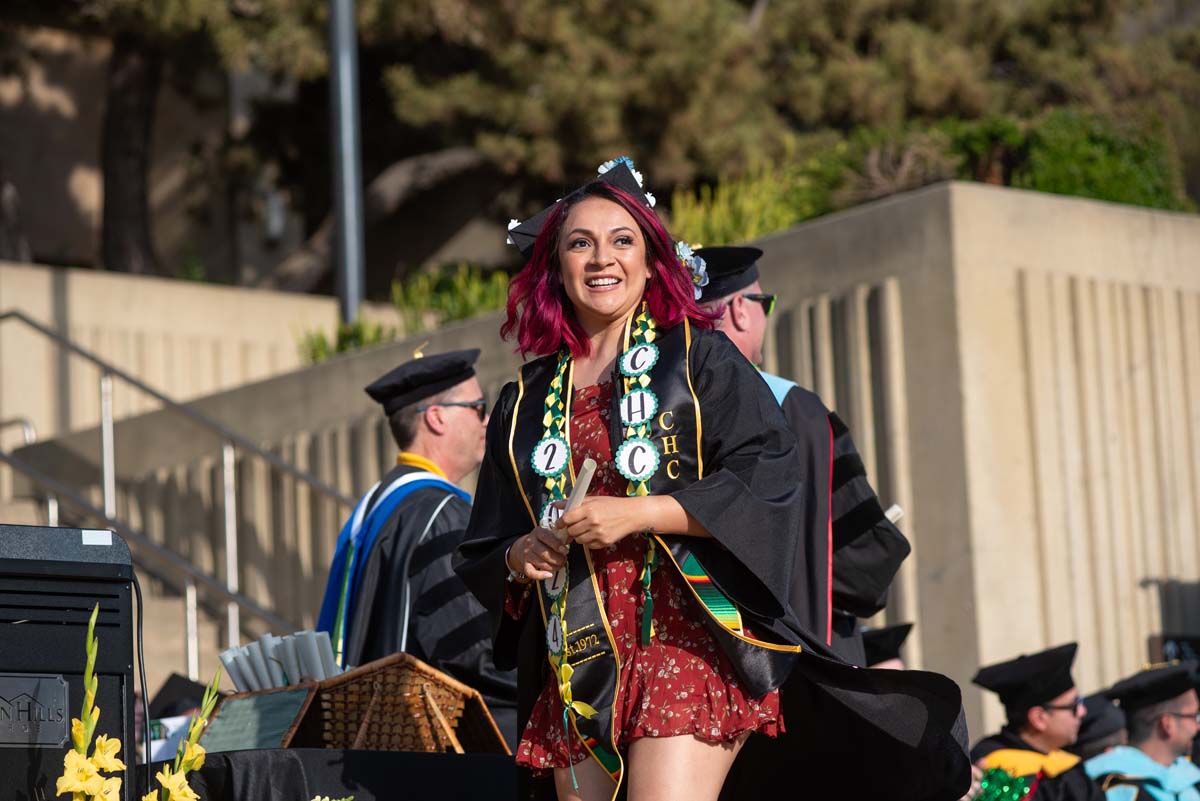 Graduates walk across stage at CHC Commencement 2024.