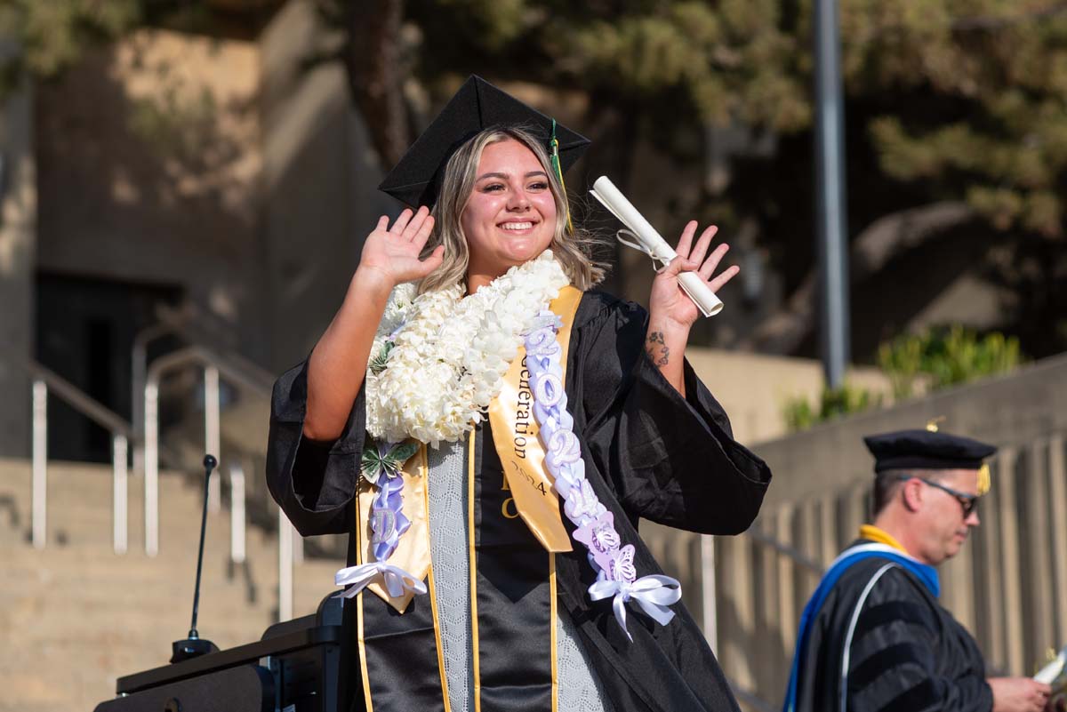 Graduates walk across stage at CHC Commencement 2024.