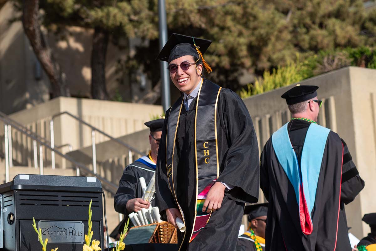 Graduates walk across stage at CHC Commencement 2024.