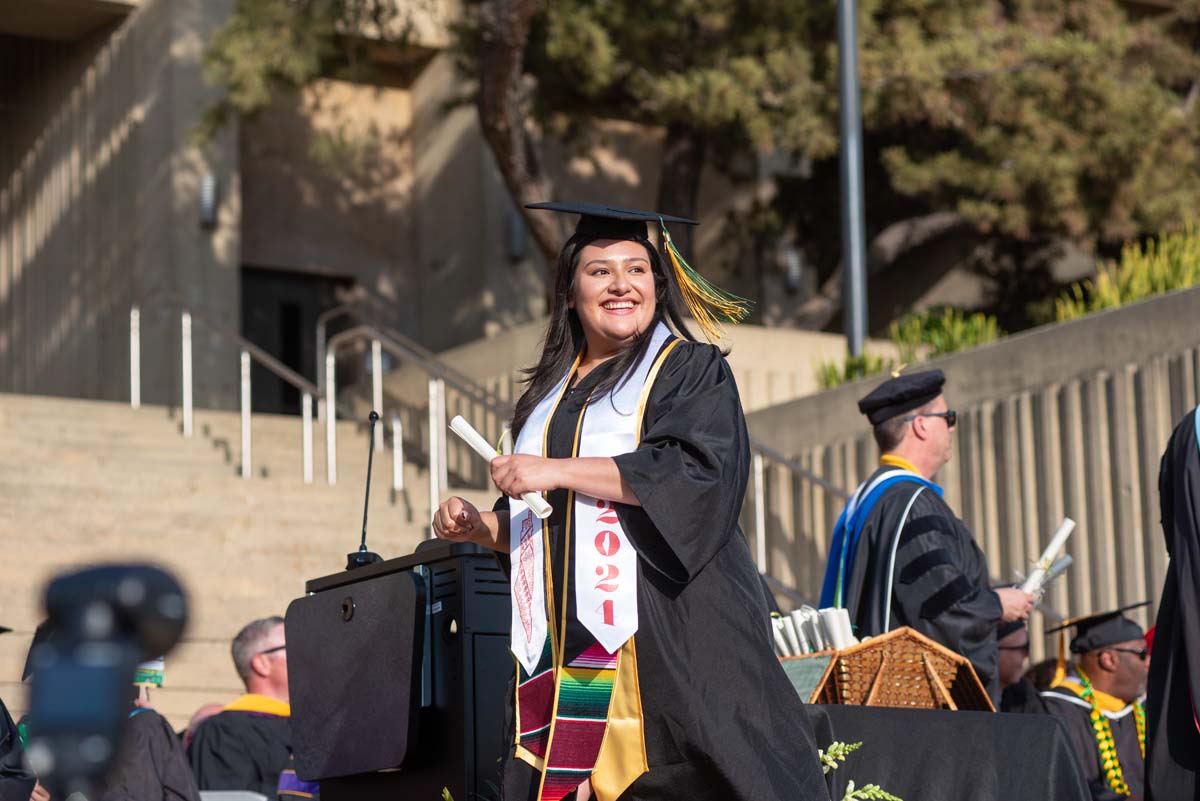 Graduates walk across stage at CHC Commencement 2024.