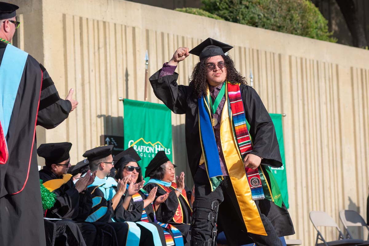 Graduates walk across stage at CHC Commencement 2024.