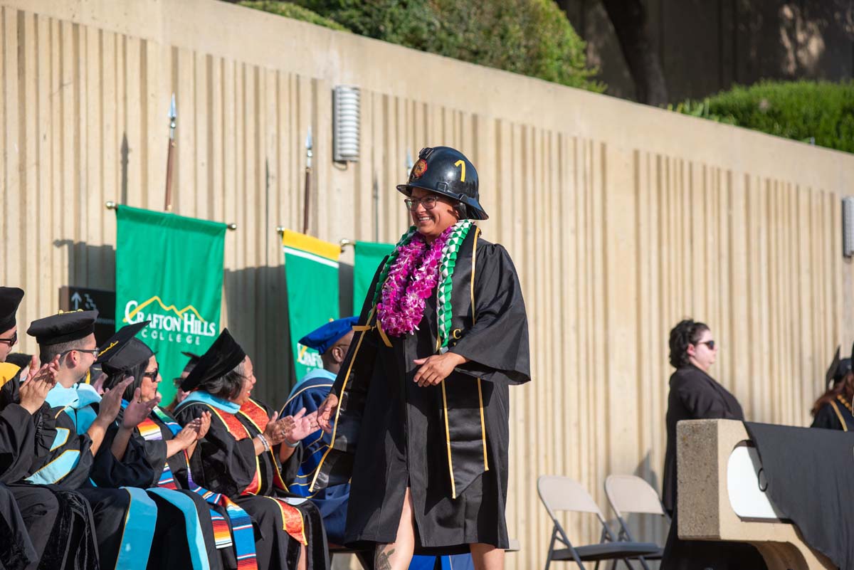 Graduates walk across stage at CHC Commencement 2024.