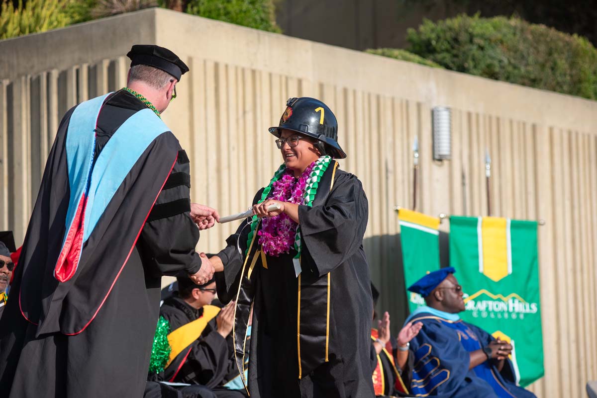 Graduates walk across stage at CHC Commencement 2024.