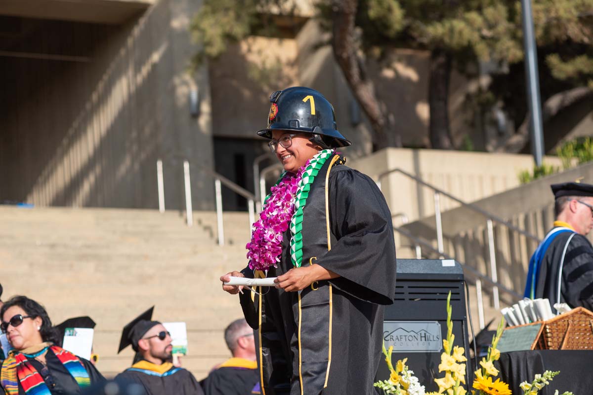 Graduates walk across stage at CHC Commencement 2024.